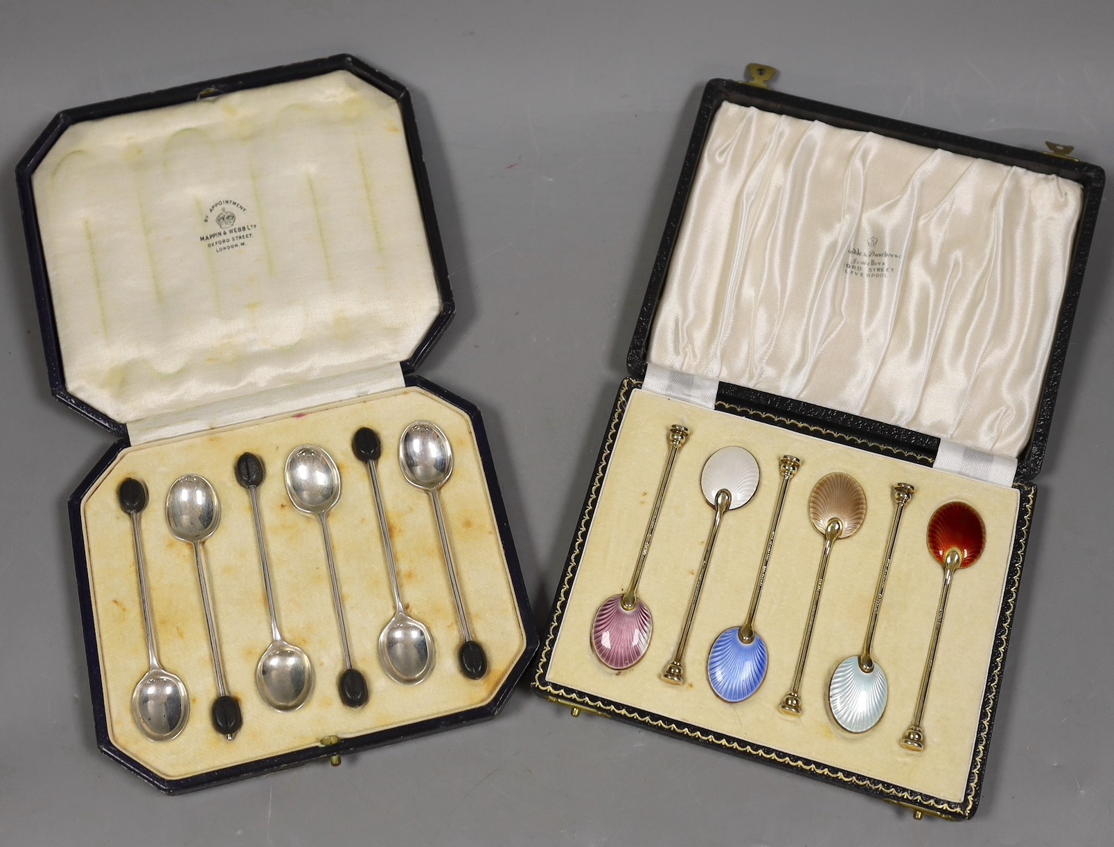 A cased set of six Elizabeth II silver and polychrome enamelled coffee spoons, Birmingham, 1960 and a cased set of six silver bean end coffee spoons.